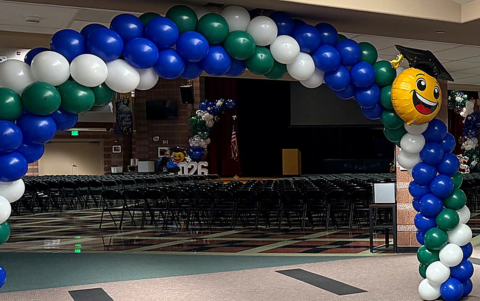 A coordinated installation with a balloon arch and multiple accent columns