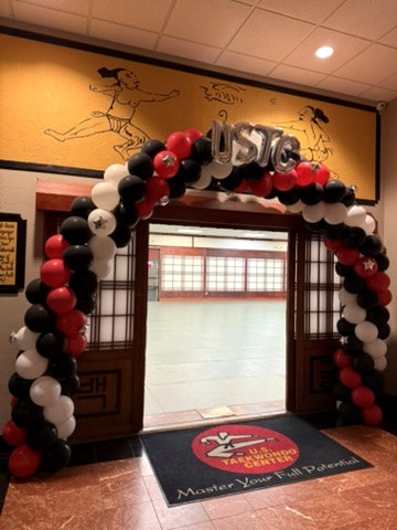 Blown Away black, red and white balloon arch framing an event entrance