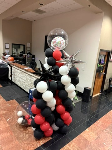 Red, white and black balloon column with metallic star accents
